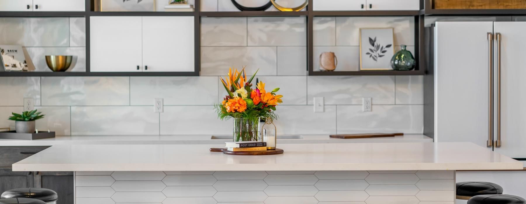 Find your perfect fit at Emblem at Conyers a kitchen with stools and a vase of flowers