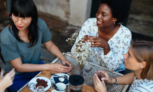 a group of women sitting at a restaurant